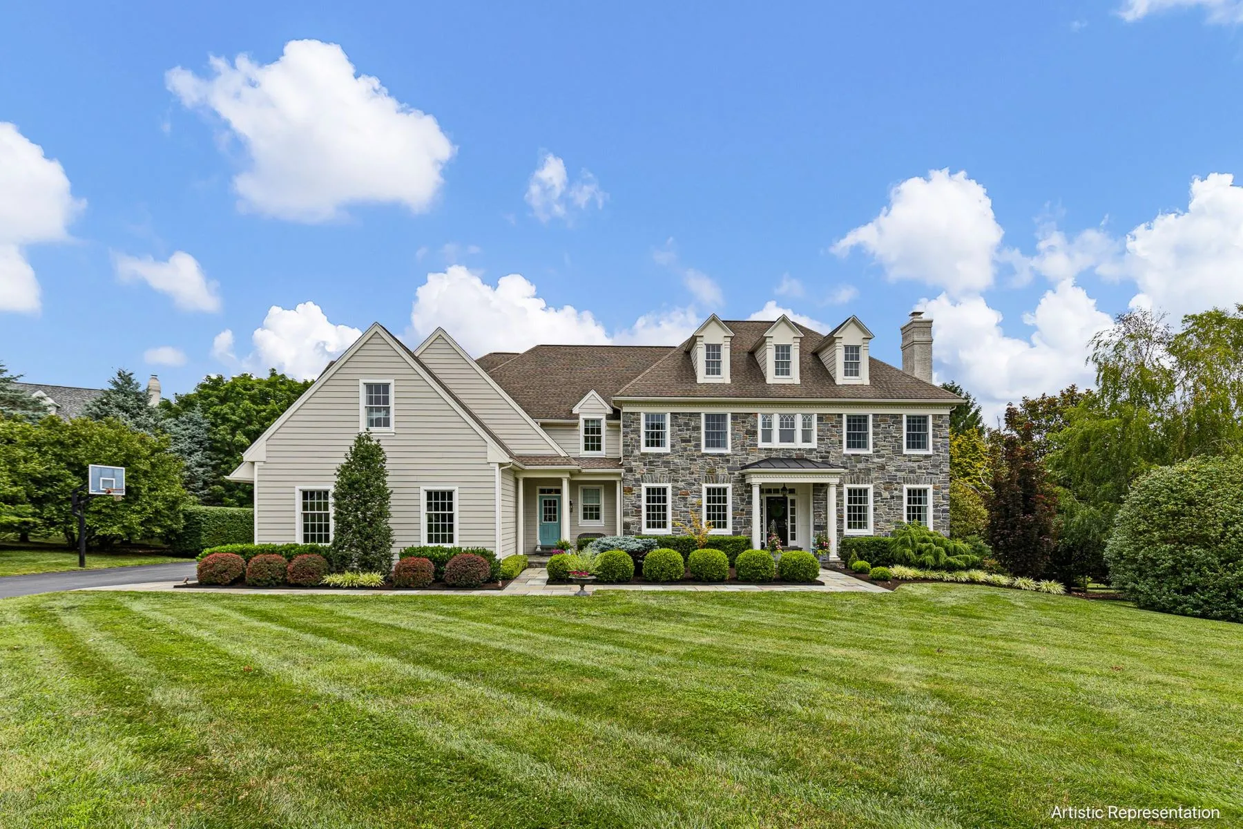 Large stone and clapboard home on a wide lawn outside downtown Kennett Square, PA